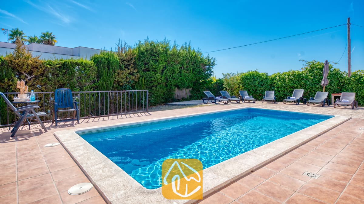 Holiday villas Costa Brava Spain - Villa Yara - Private pool with blue water and surrounding sun loungers on a paved terrace at Villa Yara in Spain.
