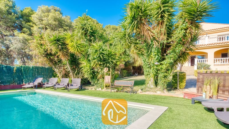 Vakantievilla's Costa Brava Spanje - Villa Summertime - Privézwembad met ligstoelen op kunstgras bij Villa Summertime, omringd door palmbomen en weelderig groen