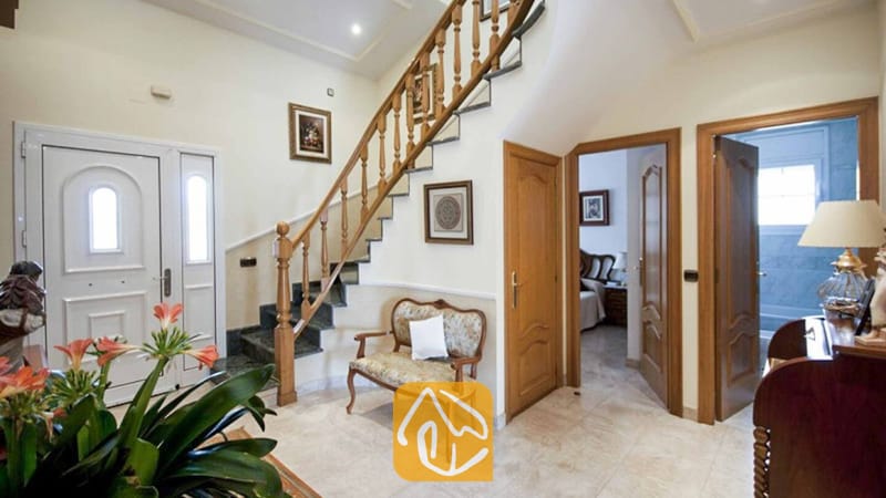 Ferienhäuser Costa Brava Spanien - Villa Mercedes Fenals - Helles Foyer mit einer Holztreppe und profilierten Stäben, Marmorfliesen und offenen Durchgängen in der Villa Mercedes Fenals.